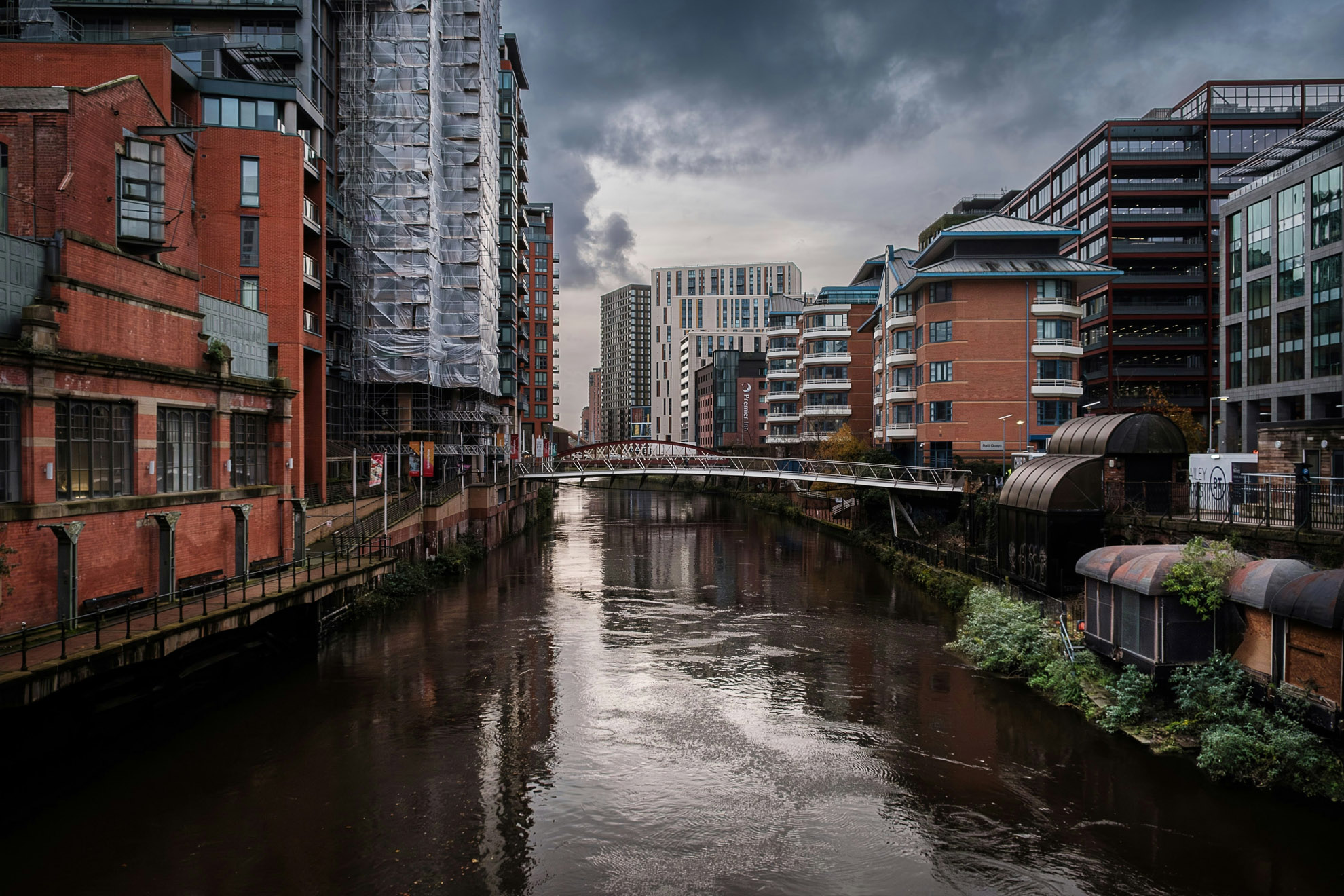 This picture features high-rise buildings in London set along a canal. The picture features residential and commercial high-rise buildings, which would be classed as a High Risk Building under the new Building Safety Act and is subject to the Building Safety Regulator regulations.